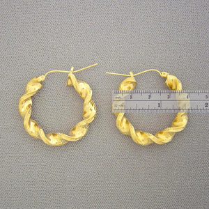 Pair of 10K real yellow gold 6mm hollow twisted hoop earrings with snap closure