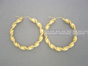 Side profile showing 6mm tube thickness of 10k yellow gold twisted hoops