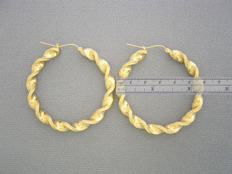Side profile showing 6mm tube thickness of 10k yellow gold twisted hoops