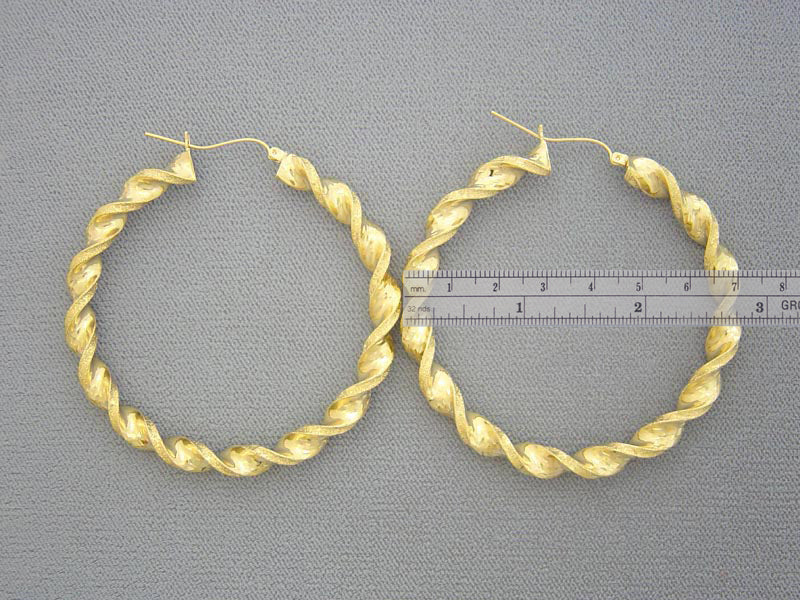 Large 2.75-inch 10K yellow gold twisted hoop earrings shown for size reference