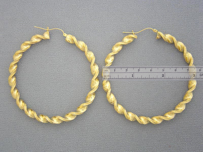 Hinged snap closure detail on 10K gold twisted hoop earring