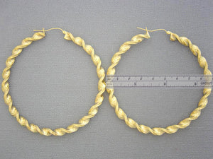Close up of textured 10K yellow gold twisted rope detail on 90mm hoop earring