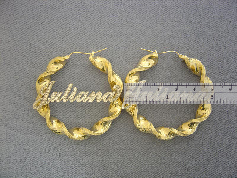 Close up of personalized script nameplate on 10K gold two-tone twisted hoop earring