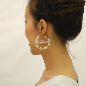 2 inch 10K gold custom iced out name hoop earrings worn on model