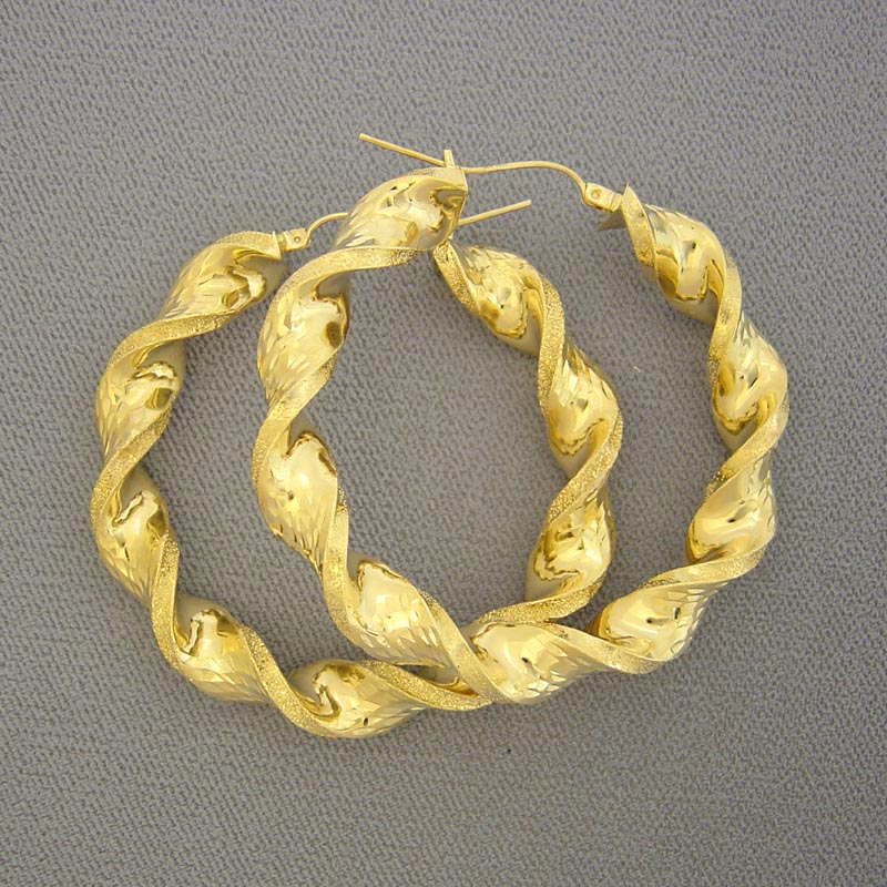 Hinged snap closure detail on 10K gold 8mm twisted hoop earring