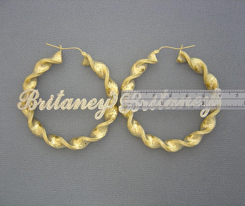 Close-up of personalized iced out nameplate on 10K gold 2.3 inch twisted hoop