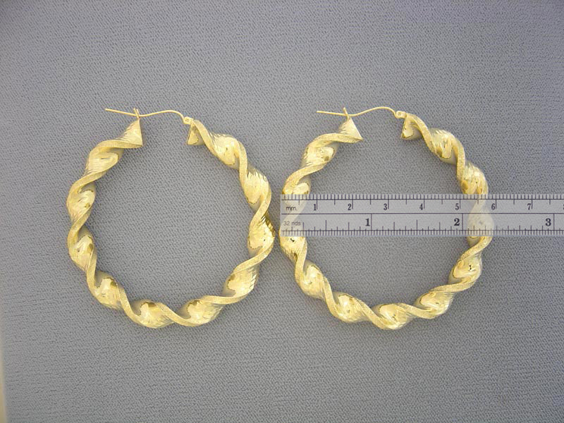 Side view of 10K yellow gold 8mm twisted hoop earring showing clip closure