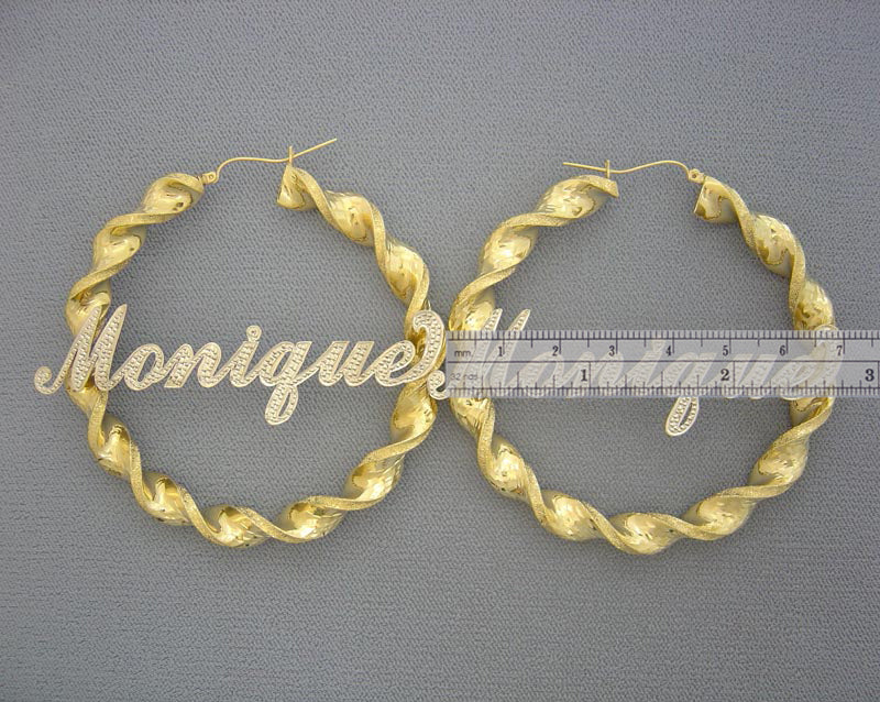 Close-up of two-tone personalized iced out letters on 8mm gold twisted hoop earrings