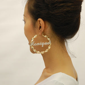 Model wearing 2.75 inch 10k gold custom iced out name hoop earrings