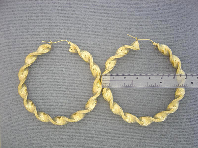 Close up view of 10K gold 8mm twisted hoop earring hinged snap closure