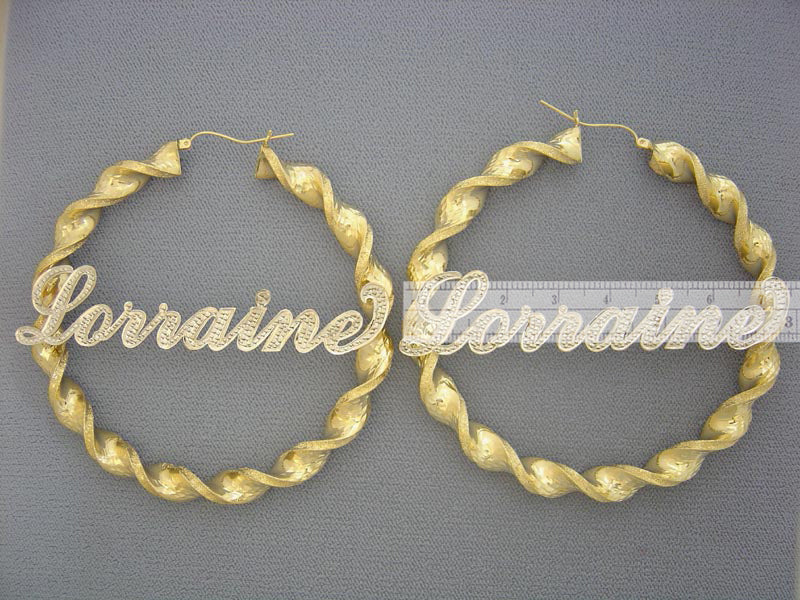 Close-up detail of two-tone iced out custom name on 10k gold hoop earring