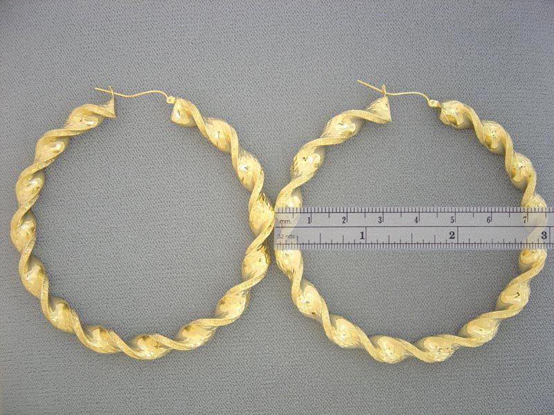 Close-up of secure clip-back clasp on 8mm hollow 10k gold twisted hoop earring