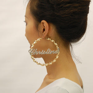 Detail view of 10K two tone gold iced out lettering on 8mm twisted hoop earring