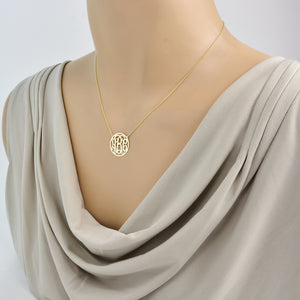 personalized 3-initial solid gold circle monogram pendant necklace on a rolo chain on mannequin