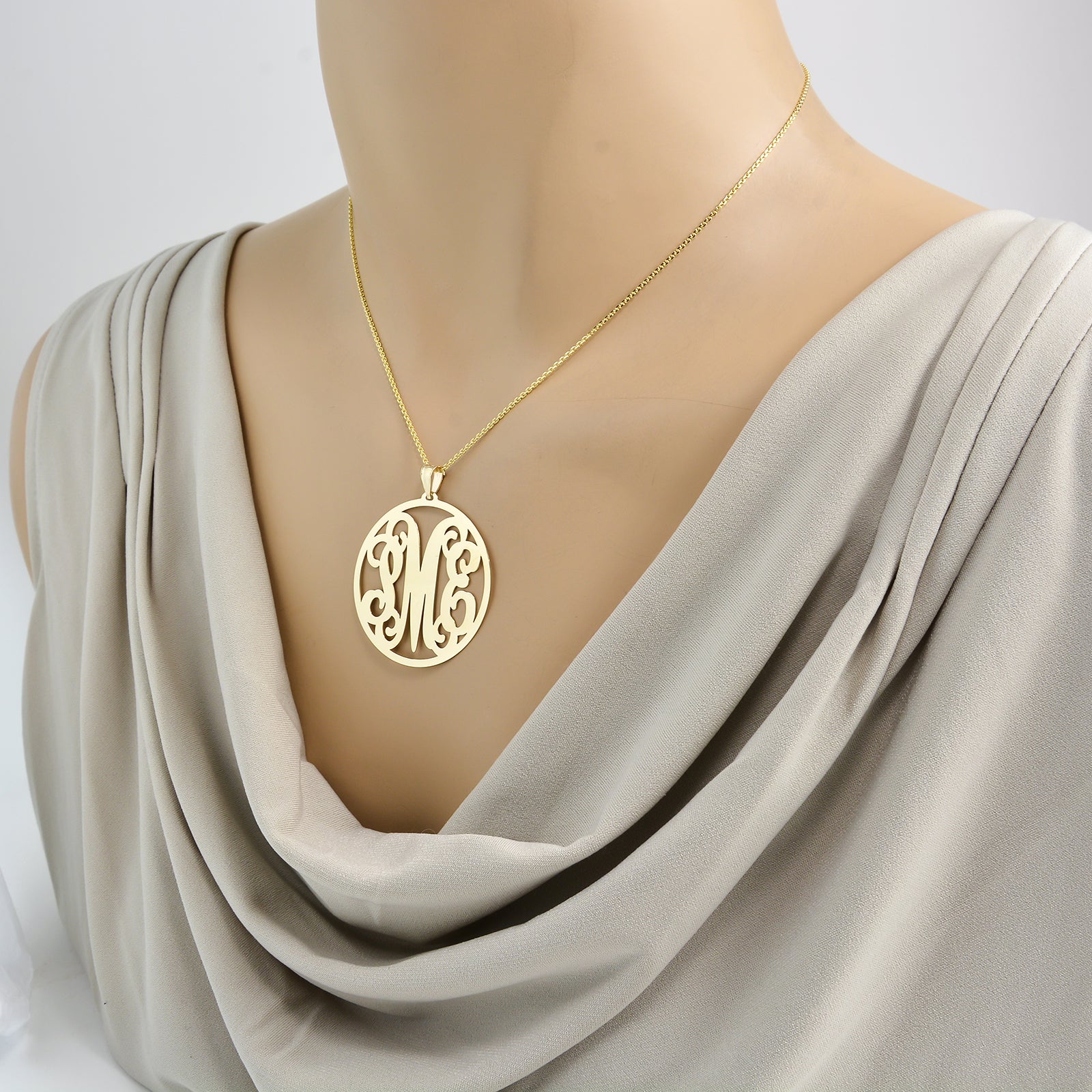 Solid gold custom monogram necklace on a gold rolo chain on mannequin