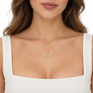 Model wearing a personalized solid gold heart monogram necklace with three initials
