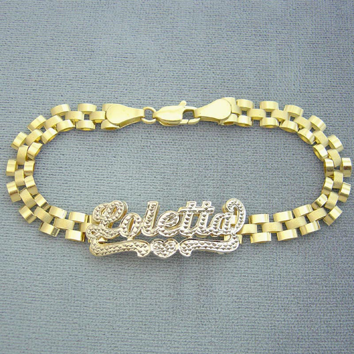 Detail of hand-engraved 3D iced out nameplate on 10K gold presidential link band