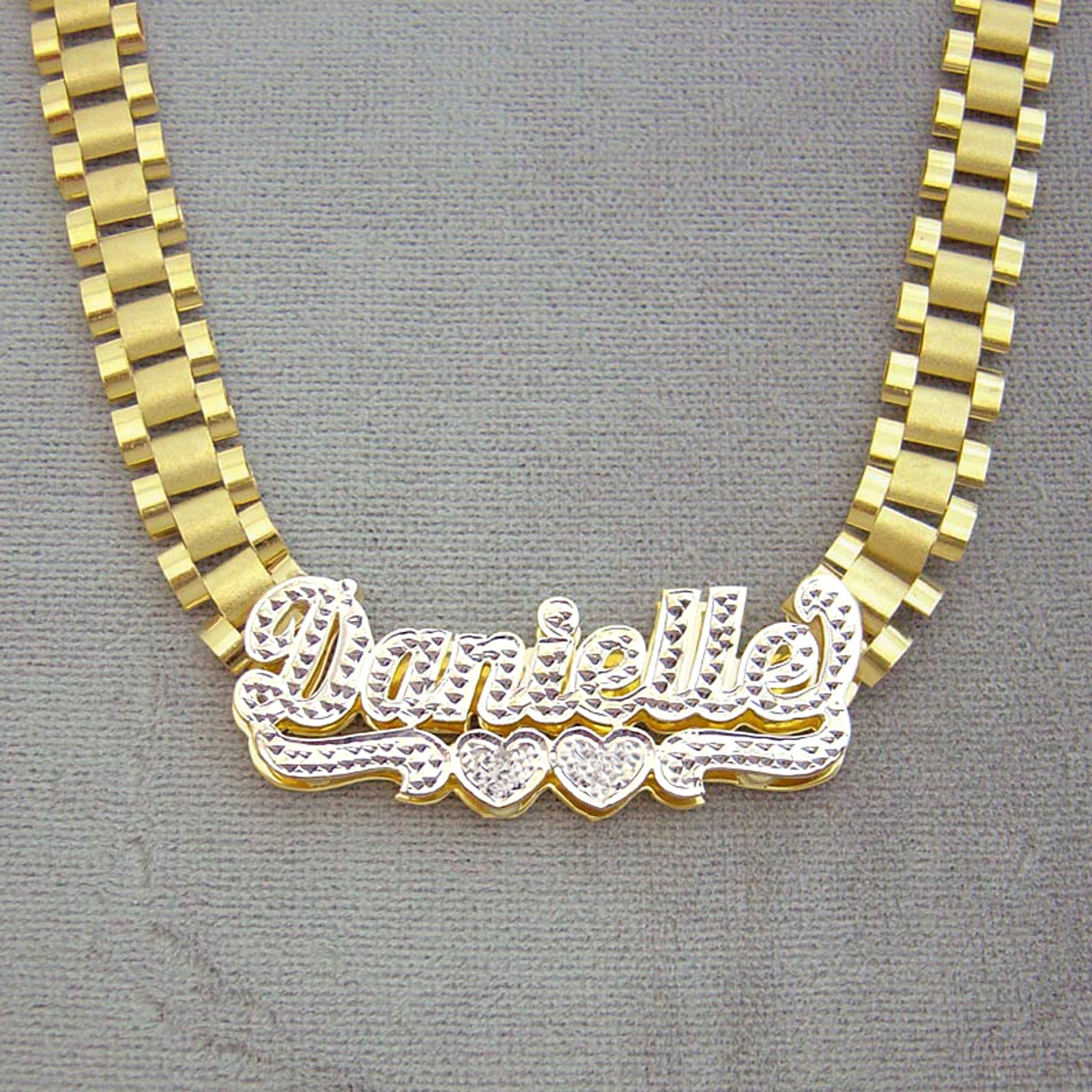Close-up front view of a 3D hand-engraved 10K yellow gold iced out name necklace