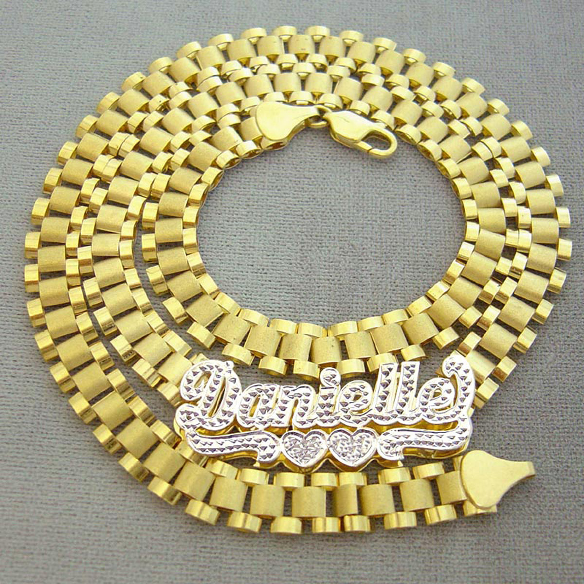 Custom 10K solid yellow gold iced out Danielle nameplate chain coiled flat showing watch-band links