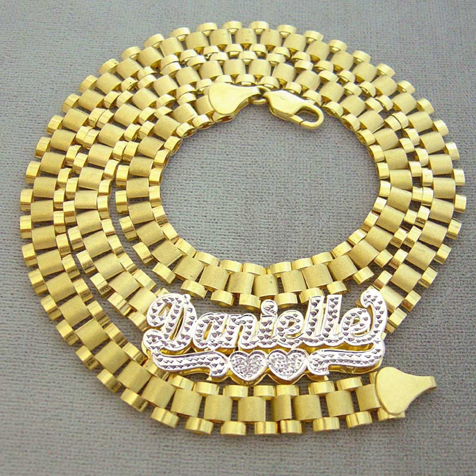 Custom 10K solid yellow gold iced out Danielle nameplate chain coiled flat showing watch-band links