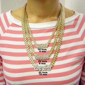 Model wearing custom iced out name necklace layered with multiple gold chains