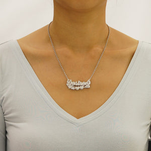 Model wearing a personalized silver Cupid's arrow nameplate necklace on an 18-inch Rolo chain.