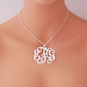 Woman wearing a personalized sterling silver 3-initial monogram pendant necklace