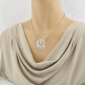 Model wearing a 1.25 inch sterling silver circle monogram necklace with personalized 3-letter initials