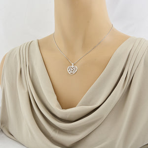 Woman wearing a personalized sterling silver 3-initial heart monogram pendant necklace.