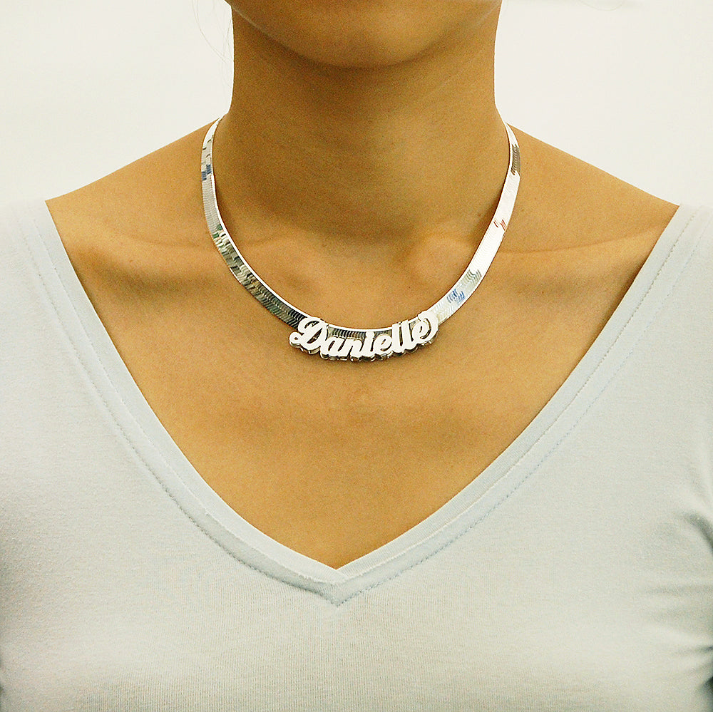 Model wearing personalized sterling silver nameplate pendant on an 8mm herringbone chain