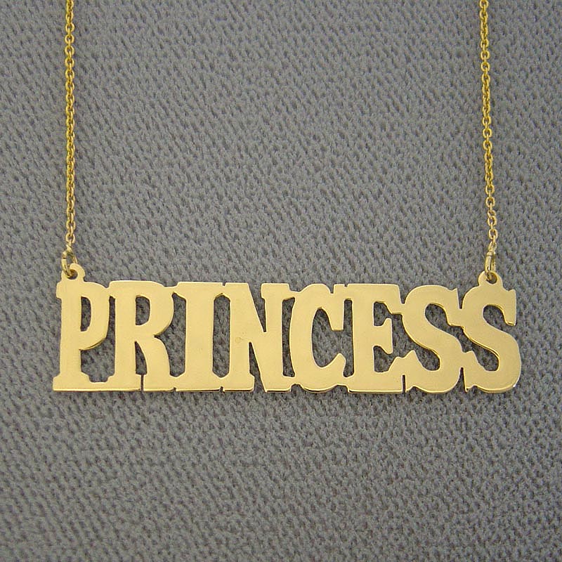 Close-up detail of solid 14k gold bold block lettering on a custom personalized nameplate necklace.