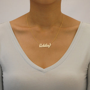 Model wearing a custom gold cursive script nameplate necklace handcrafted in solid gold.