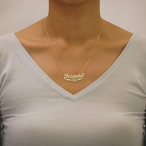Close-up view of a custom gold Quinceañera name pendant attached to a 1.0mm Rollo chain.