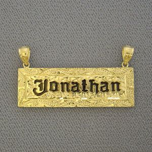 Custom solid 14k yellow gold Hawaiian heirloom name pendant featuring hand-engraved scrollwork and black enamel lettering reading 'Jonathan'.
