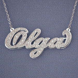 10K or 14K solid gold custom cursive diamond name necklace featuring handset genuine diamonds on a double-plate pendant.