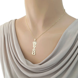 Gold vertical KING crown nameplate pendant and chain displayed on a mannequin with a draped gray neckline