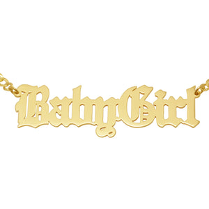 Detail view of a laser-cut Old English gothic font name necklace in solid yellow gold.