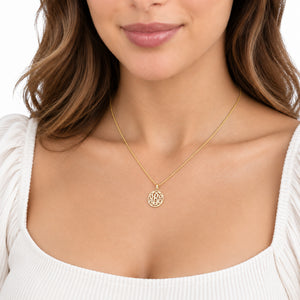 Model wearing a custom extra-small solid gold 3-initial circle monogram pendant necklace.