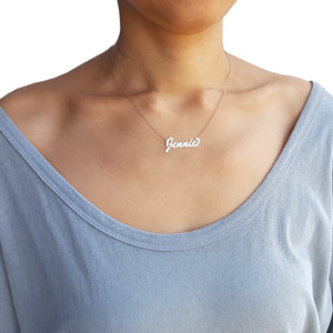 Model wearing the small personalized solid gold script nameplate necklace fitted close to the neck on a 14-inch chain.