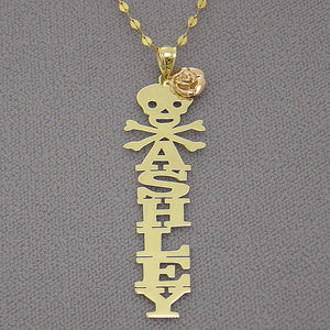 Personalized 10k yellow gold vertical name pendant featuring custom block lettering with a rose gold flower, skull, and crossbones top emblem.
