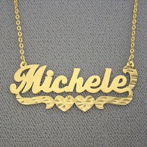 Personalized 14k yellow gold nameplate necklace with hearts and diamond-cut detailing spelling out the name "Michele".
