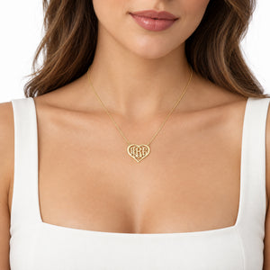 Woman wearing a personalized solid gold three-initial heart monogram necklace