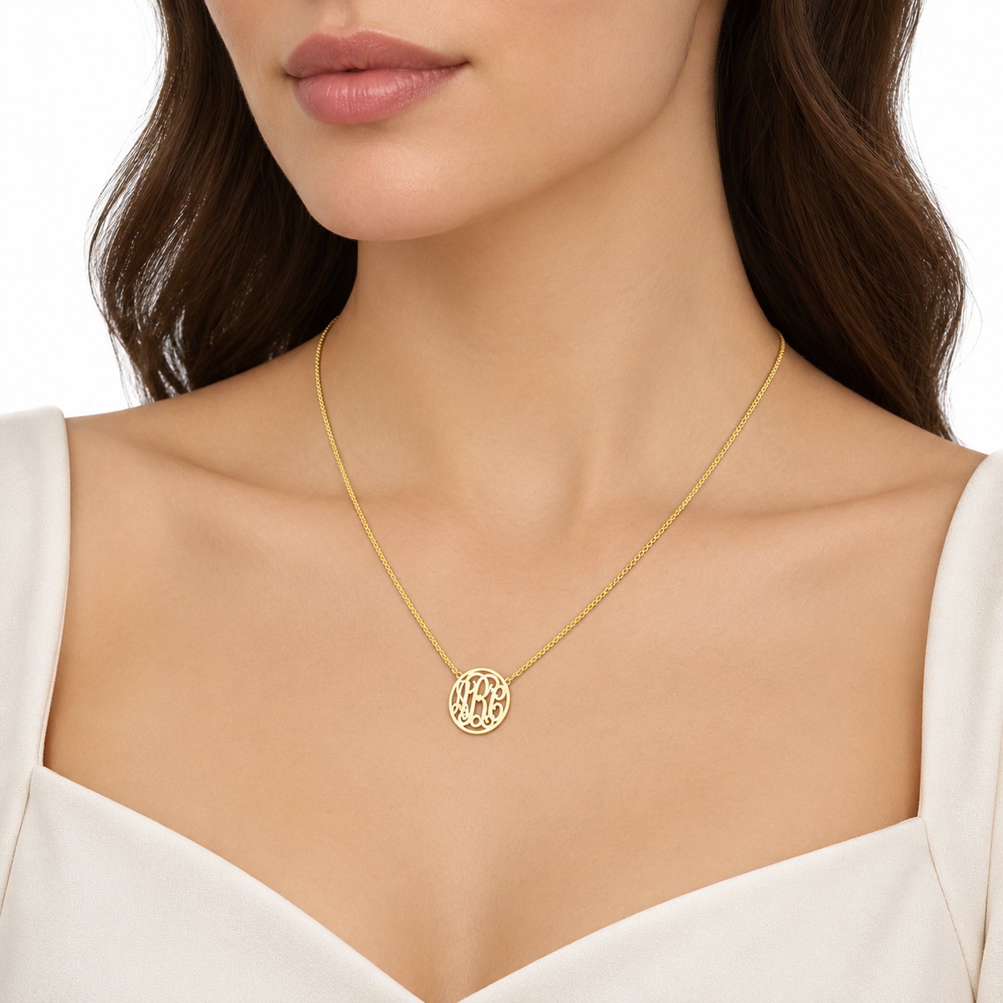 Woman wearing a small personalized solid gold three-initial circle monogram necklace.