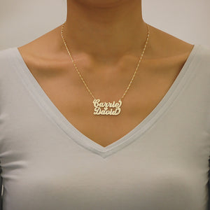 Woman wearing the custom solid gold double nameplate heart necklace to show length, scale, and fit.