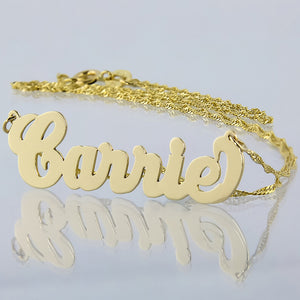 Small 10k yellow gold cursive Carrie script name necklace on a white background