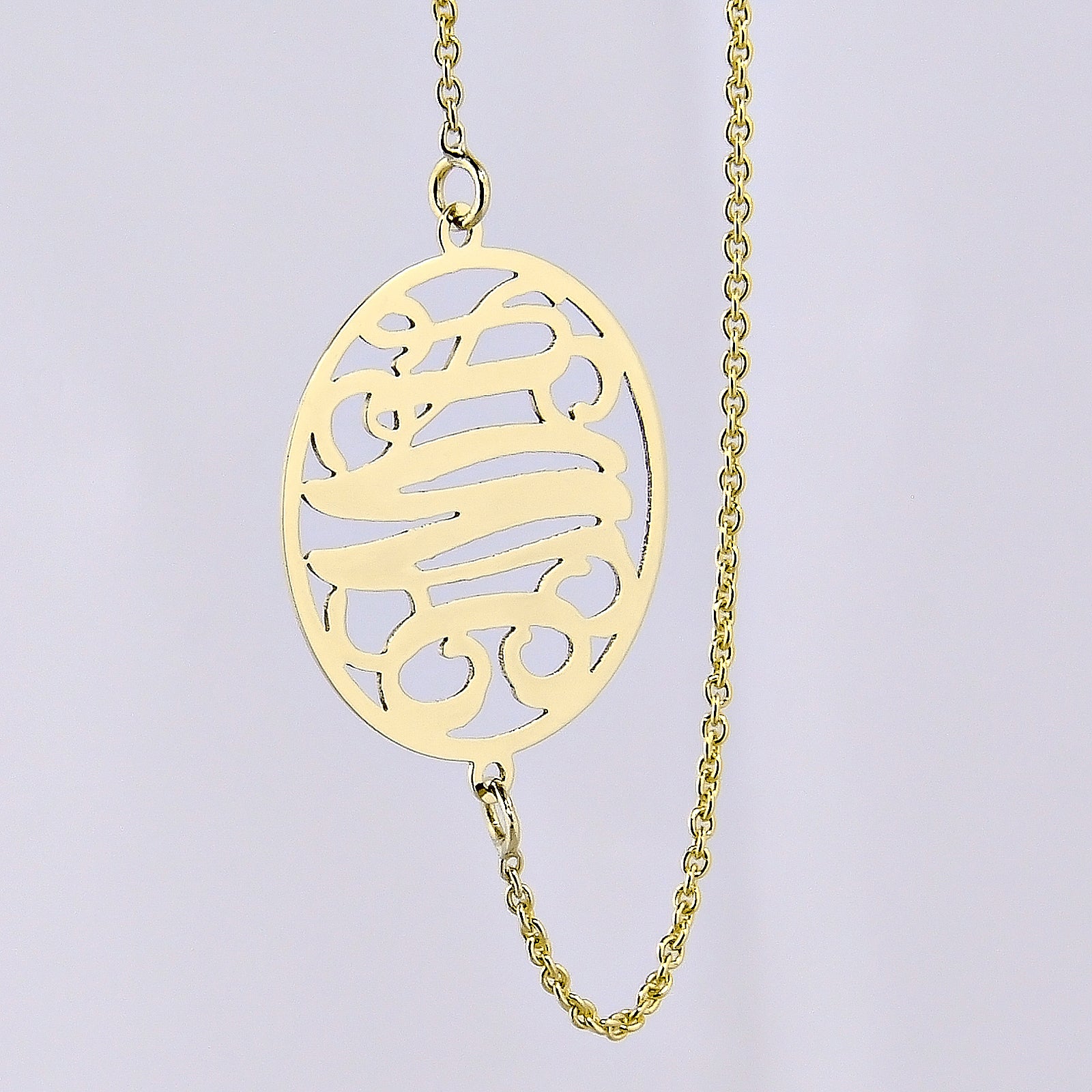 Small gold three-initial circle monogram necklace on a fine chain