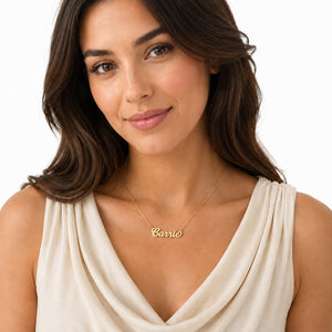 Dainty custom gold Carrie script name necklace on a model wearing a sleeveless top.