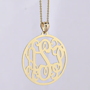 10k or 14k solid gold three-initial circle monogram pendant on a gold chain against a lavender background