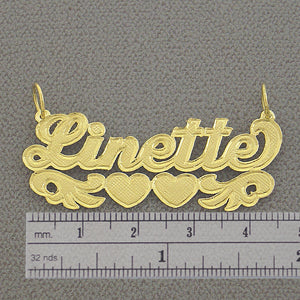 Side view highlighting the 0.7 mm thickness of the solid gold custom name pendant.