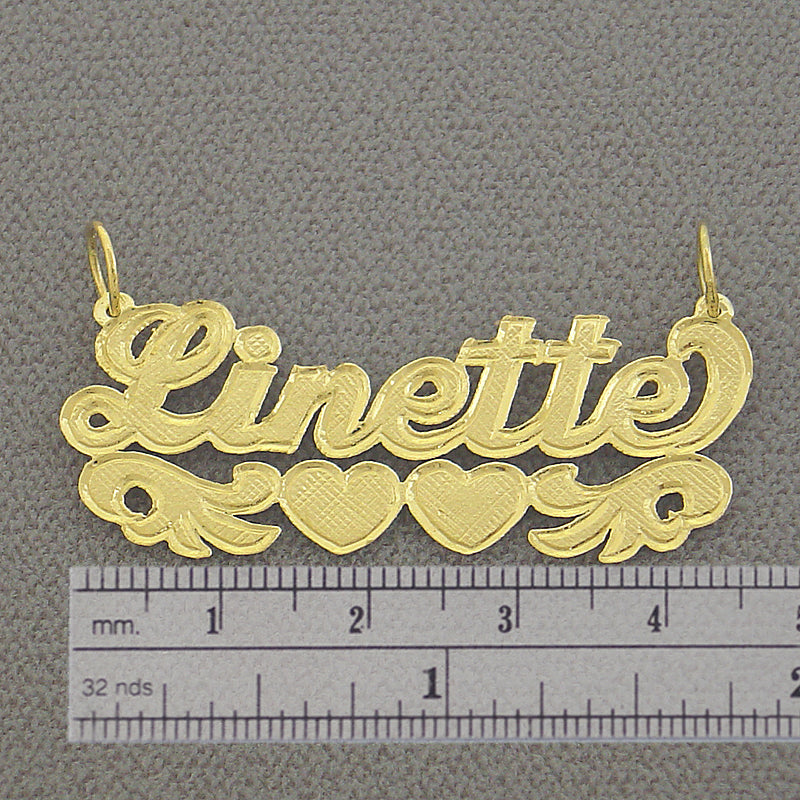 Side view highlighting the 0.7 mm thickness of the solid gold custom name pendant.